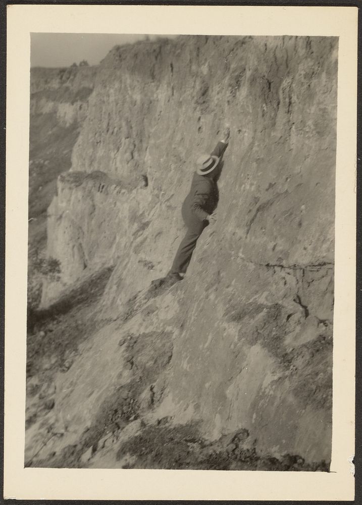 Man Wearing Suit Scaling Rocks by Louis Fleckenstein