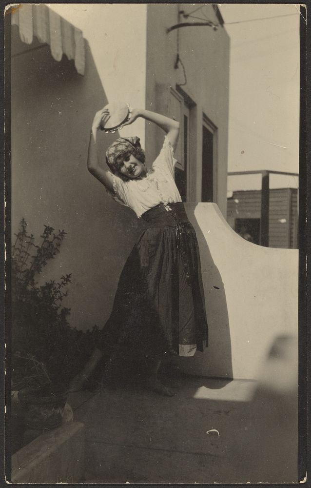 Woman Posing Before House with Tambourine by Louis Fleckenstein
