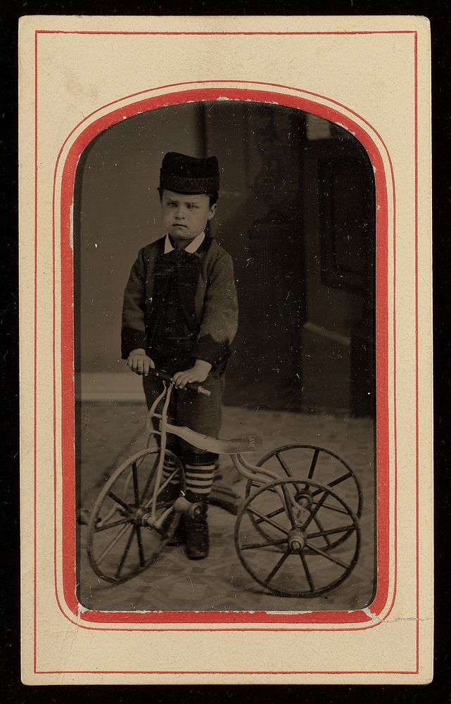 Portrait of a Boy in Cap with Tricycle