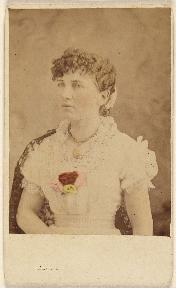 Unidentified woman wearing flower embellished dress, seated