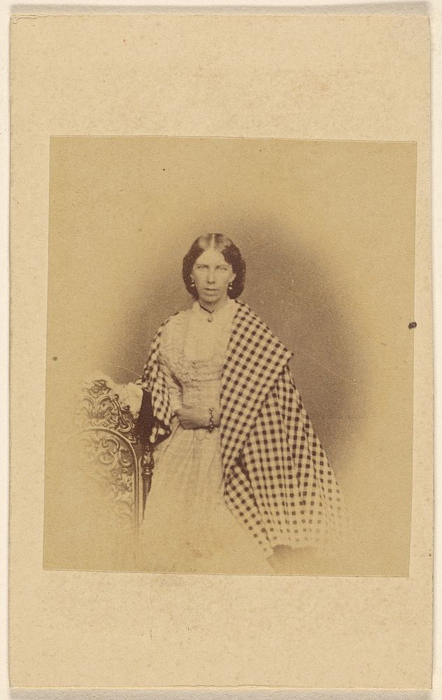 Unidentified woman with checkered shawl, standing