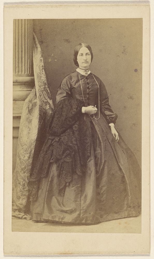 Unidentified woman in long black dress, standing by F Schwarzschild