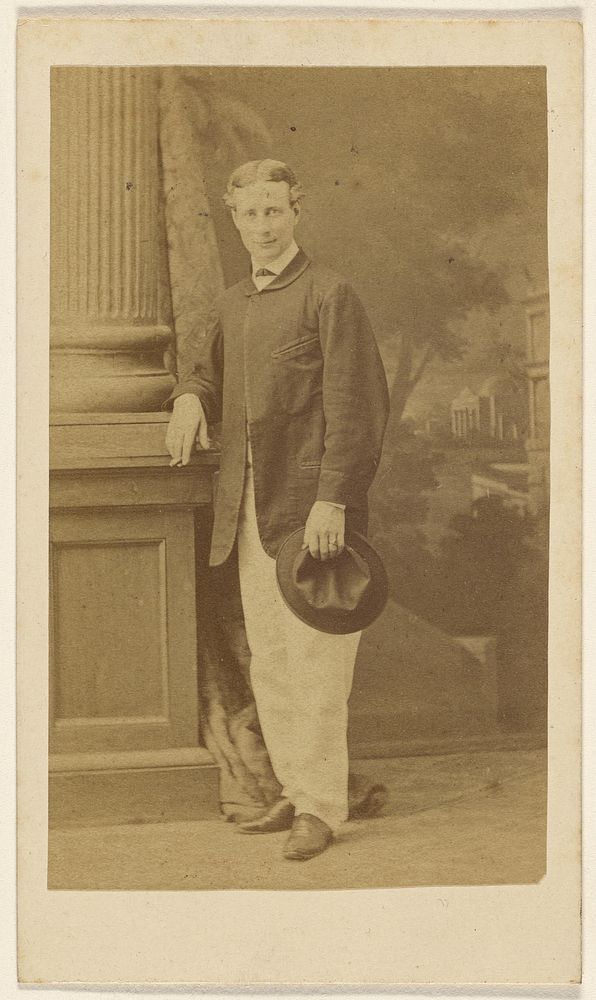 Unidentified young man standing with cigar in one hand, his hat in the other by F Schwarzschild