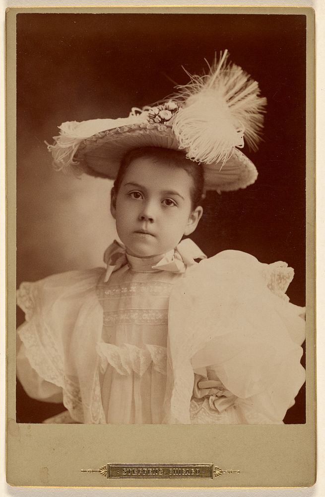Unidentified little girl in fancy white hat and dress, standing by Steffens