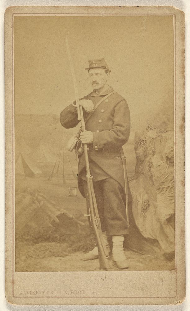 Unidentified soldier with moustache, holding rifle with bayonet, standing by Xavier Merieux