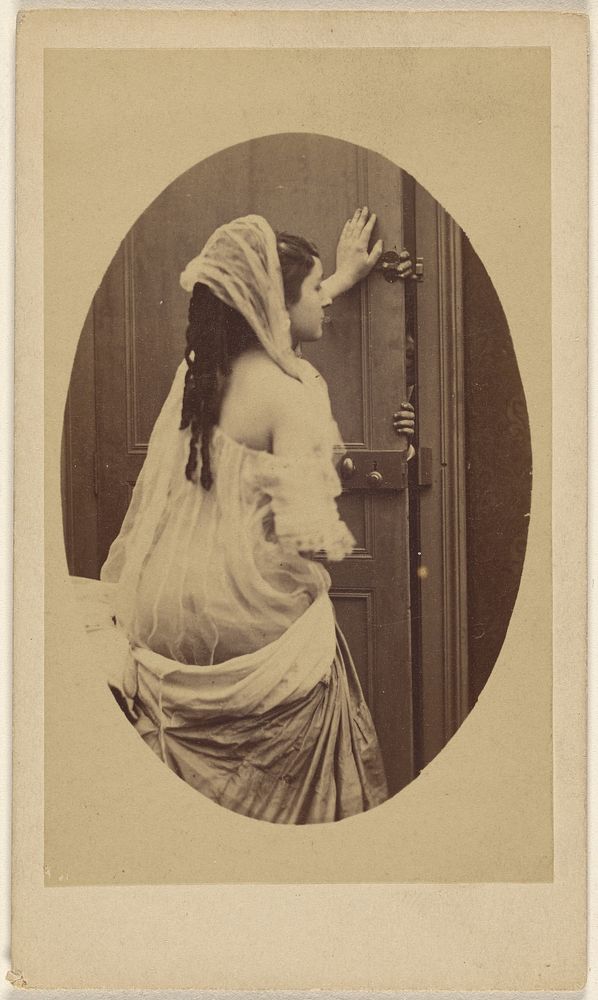 Woman with bare-shoulder gown with hand against a door preventing someone from entering