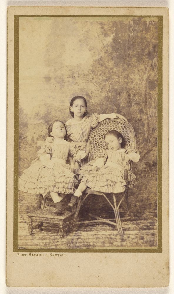 Three little girls posed on chairs in a studio by Bayard and Bertall