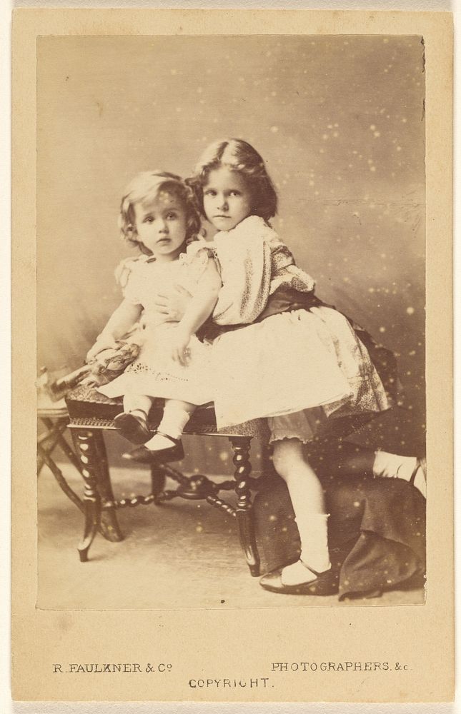 Two little girls posed on a hassock by Robert Faulkner and Co