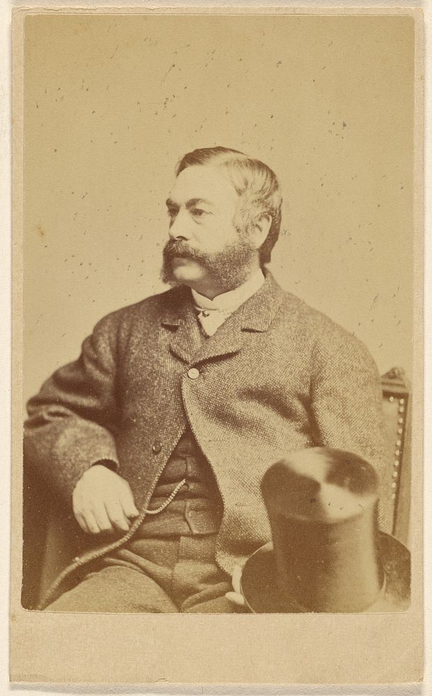Bearded man with top hat on knee, seated by J A Whipple