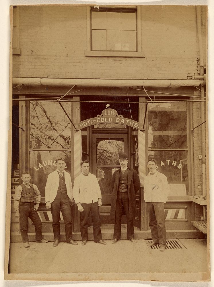 Four men and a boy standing in front of a public bath house