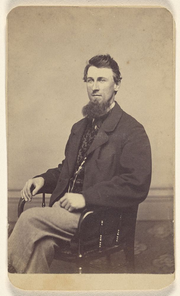 Unidentified man with long chin beard, seated by J C Moulton