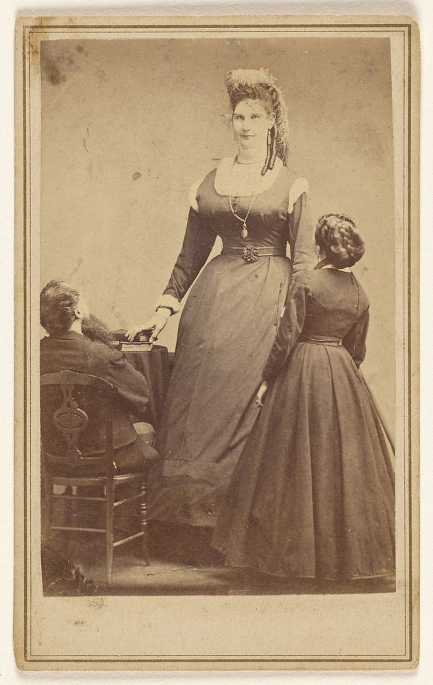 Anna Swan standing in front of two average sized people. by Edward and Henry T Anthony and Co