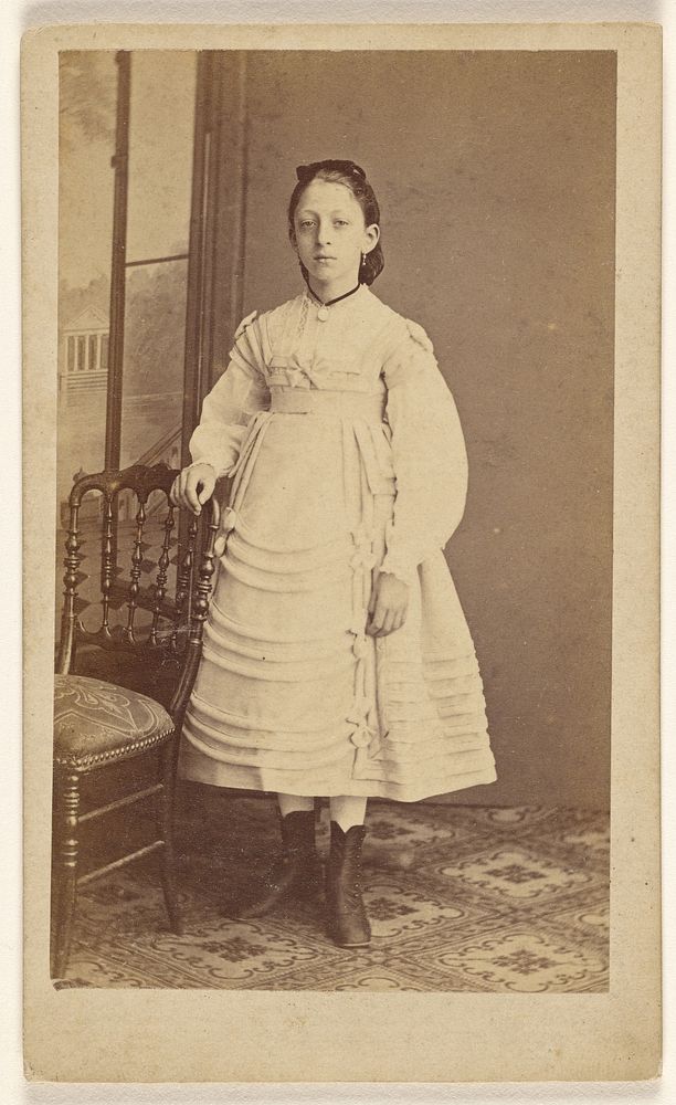 Unidentified woman, standing by J Bourens