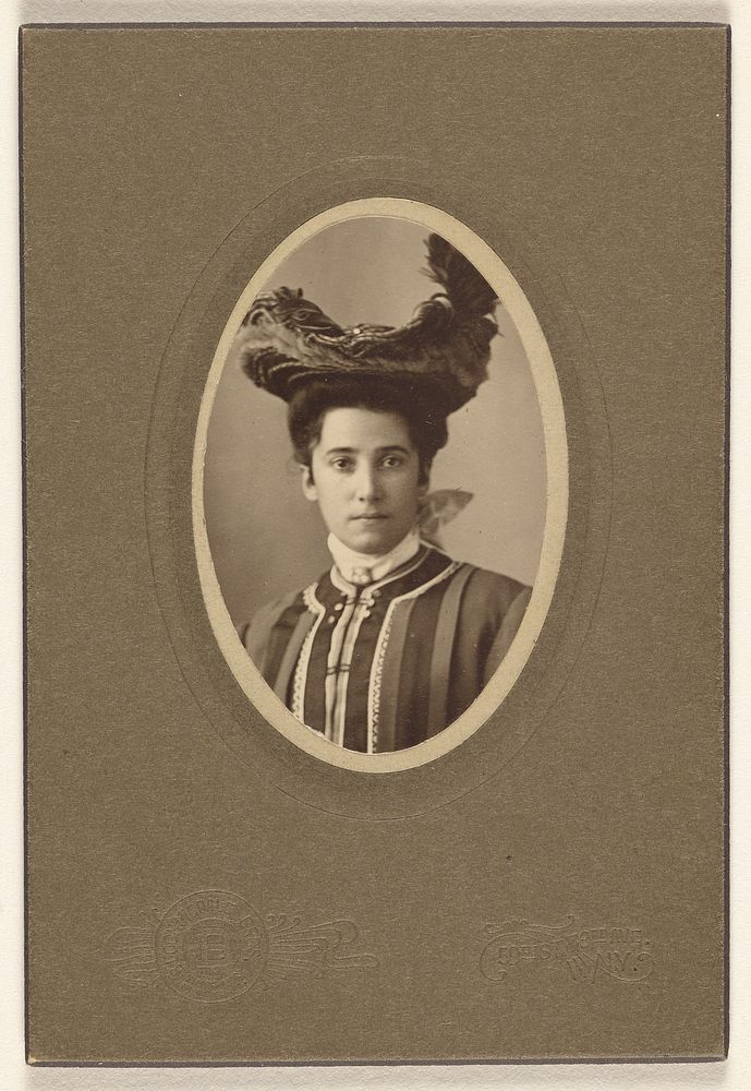 Unidentified woman wearing a feathered hat, printed in oval cut by Bloomingdale Brothers