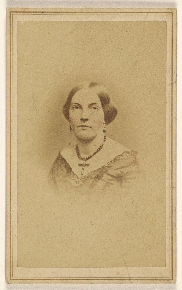 Unidentified woman wearing a crucifix necklace, printed in vignette-style by J H Bostwick
