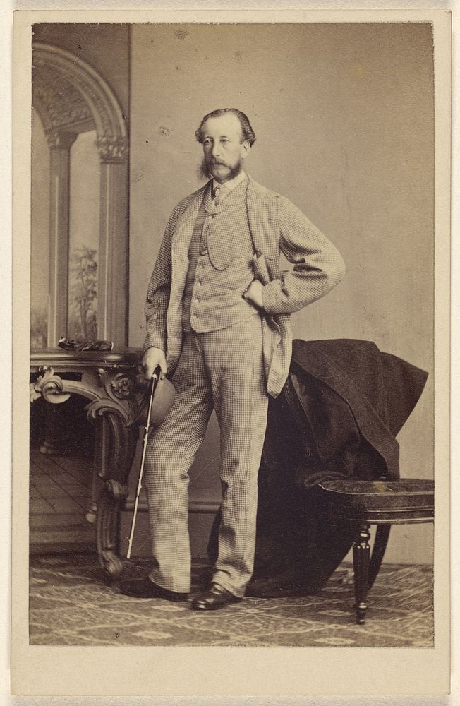 Unidentified bearded man standing, holding a walking stick by Thomas Rodger