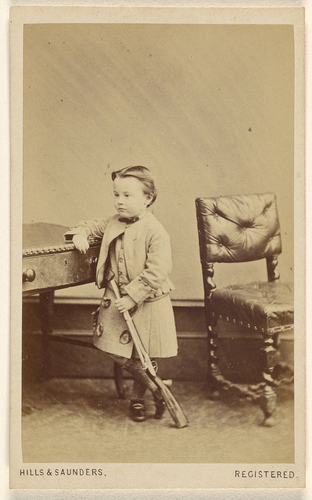 Unidentified little boy standing, holding a toy rifle by Hills and Saunders