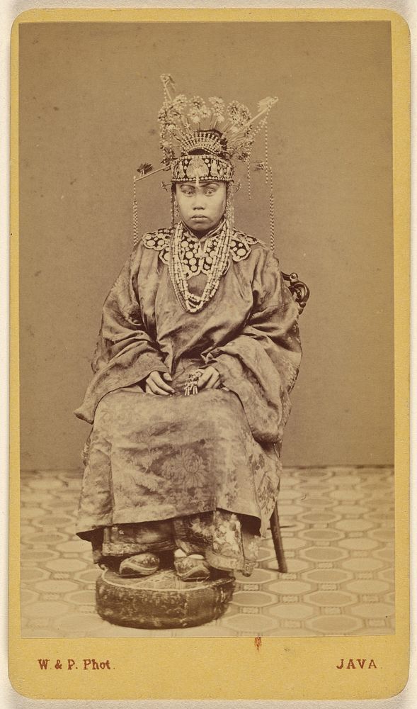 Javanese woman wearing an ornate headdress, seated by Woodbury and Page