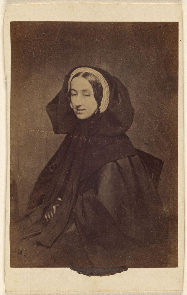 Unidentified woman dressed in all dark clothes, seated