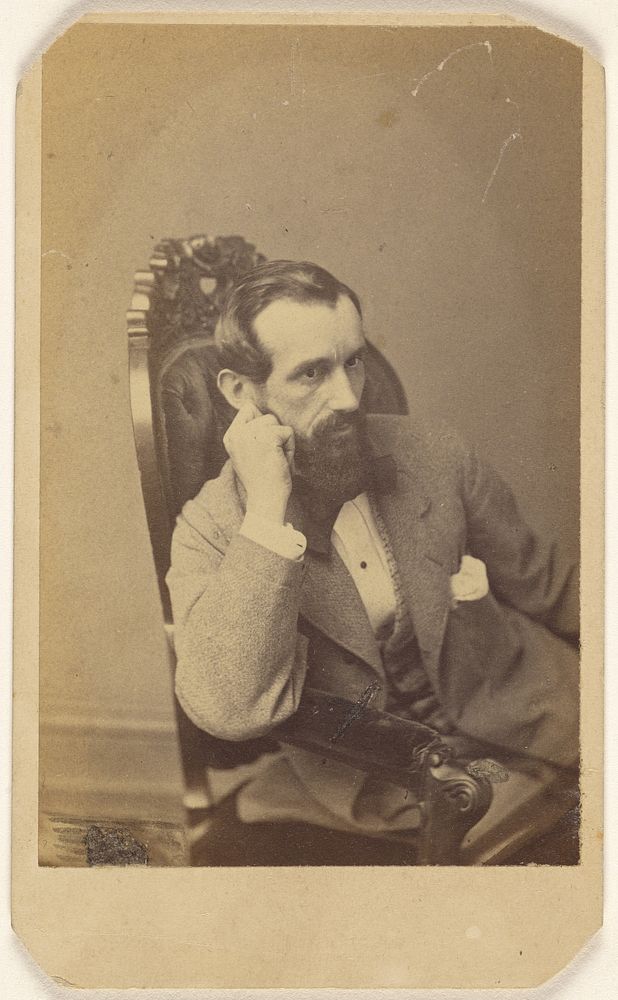 Unidentified bearded man seated with right arm on chair arm, with hand to cheek by Broadbent and Company