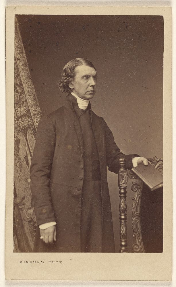 Unidentified man standing, holding a book over a chair back by Robert Jefferson Bingham