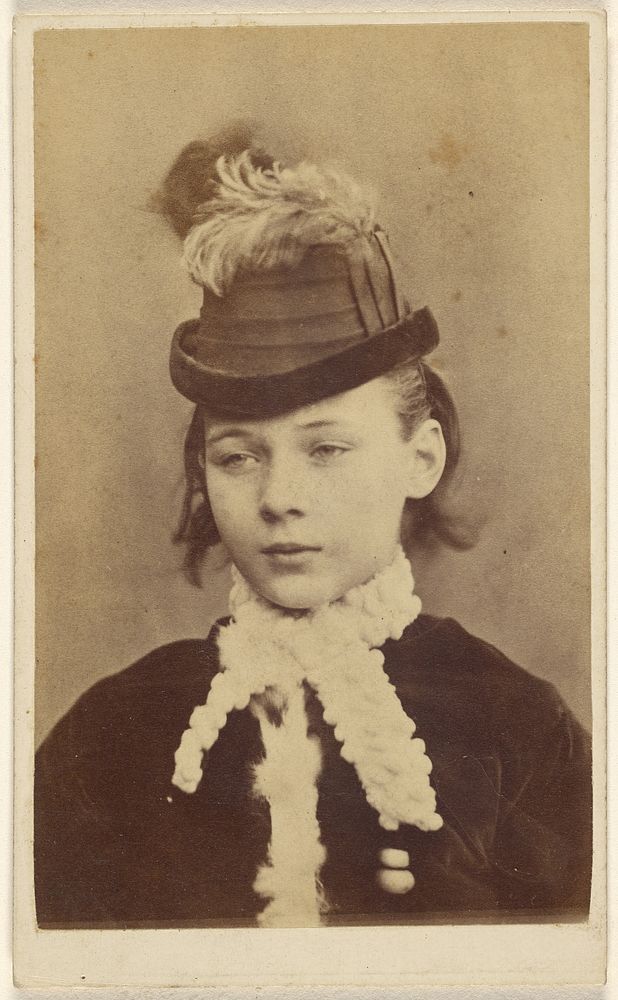 Young girl wearing a white collared velvet dress and hat