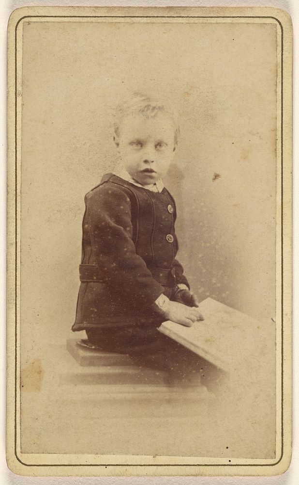 Unidentified little boy seated with an open book on his lap by John McKean
