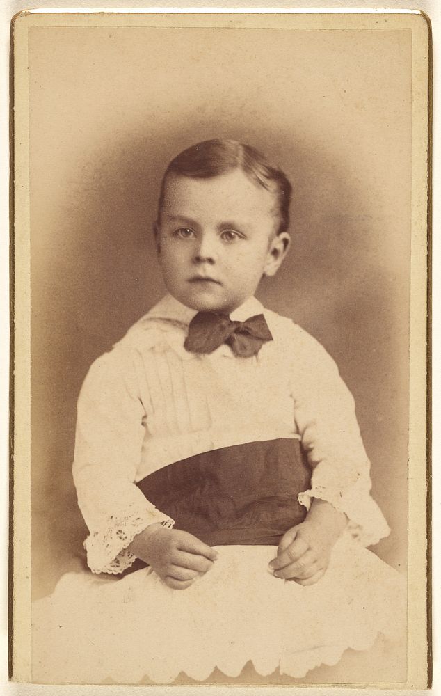 Unidentified little boy wearing a bow tie, seated by Hastings and White and Fisher