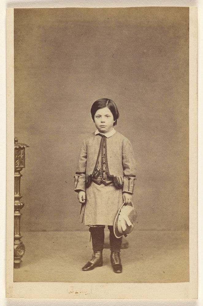 Unidentified little girl standing, holding hat by A Crowe