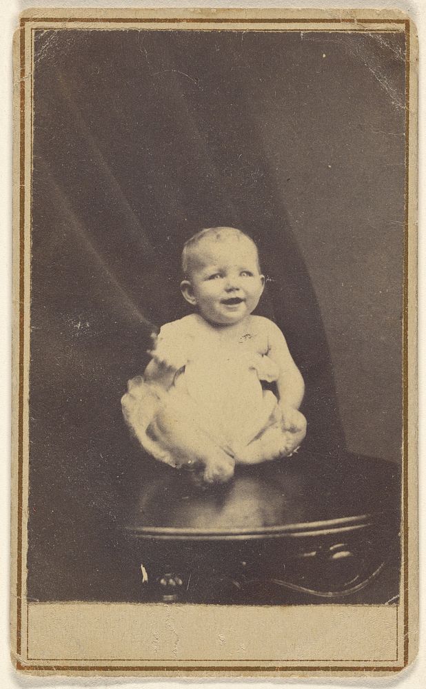 Smiling baby, sitting on a chair by W W W