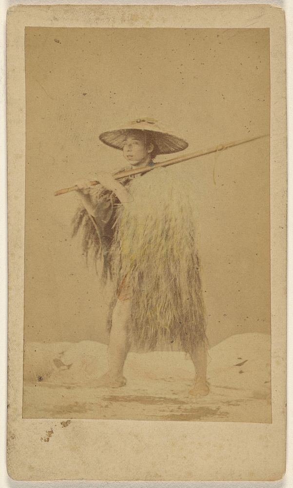 Japanese man wearing straw rain cape and hat, carrying a long pole