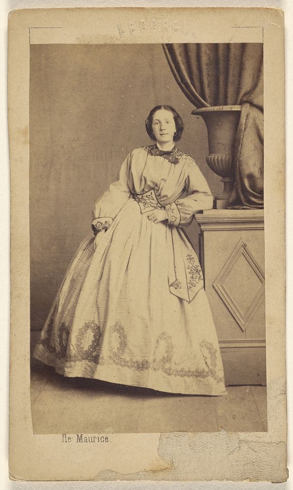 Unidentified woman, standing, leaning on a fake pillar by Ile Maurice