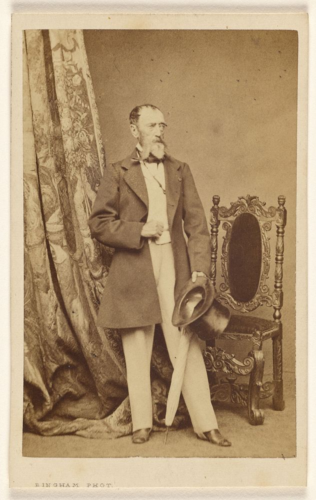 Unidentified man with full white beard, standing, holding a top hat and umbrella in his left hand by Robert Jefferson Bingham