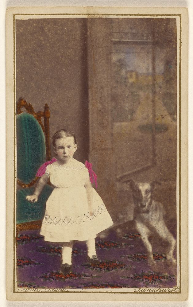 Unidentified little girl standing with a dog on the floor next to her by Bent