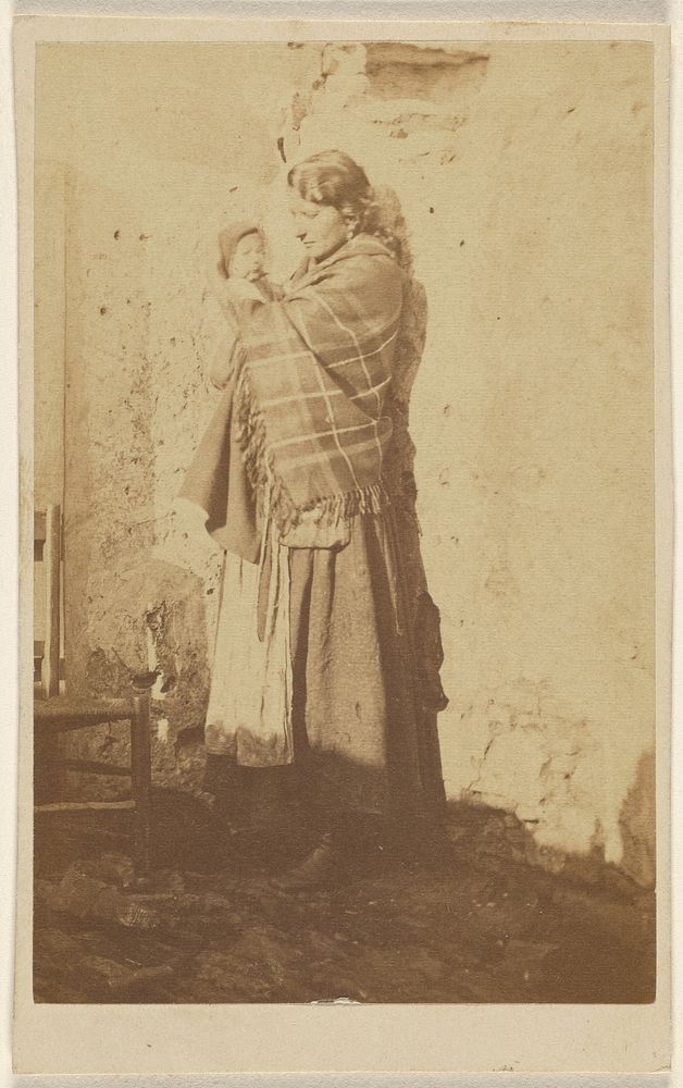 Unidentified woman wearing a shawl, holding a baby