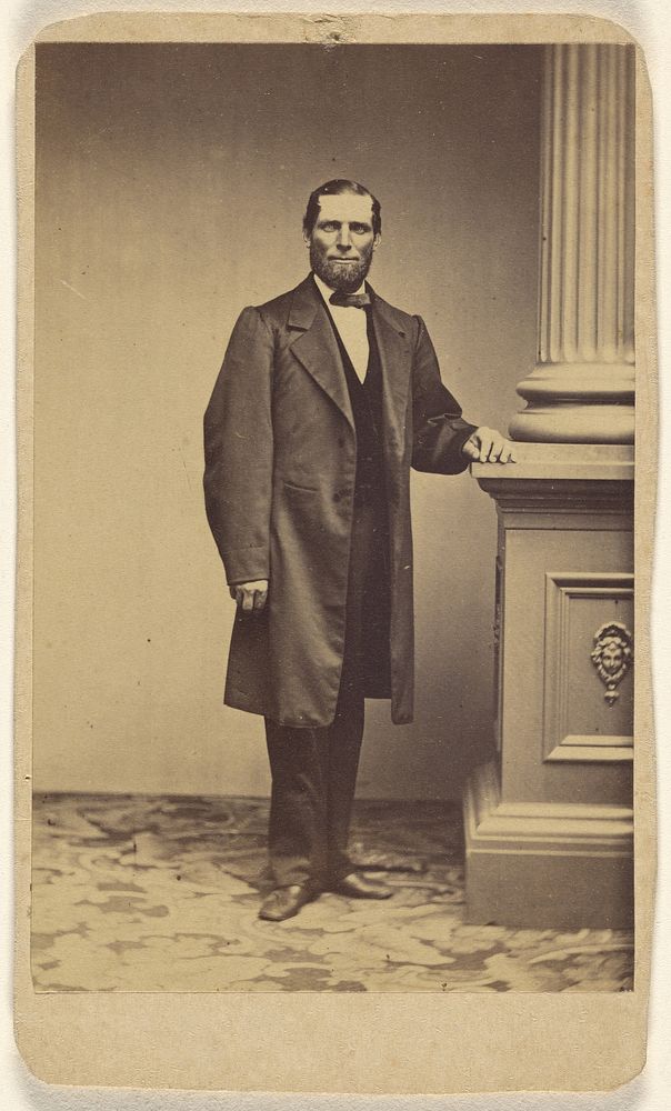 Unidentified bearded man, standing by Charles Miller