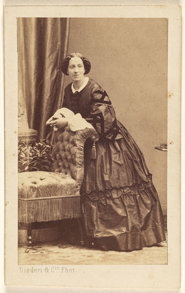 Unidentified woman standing, leaning over the back of a chair by Disdéri and Cie