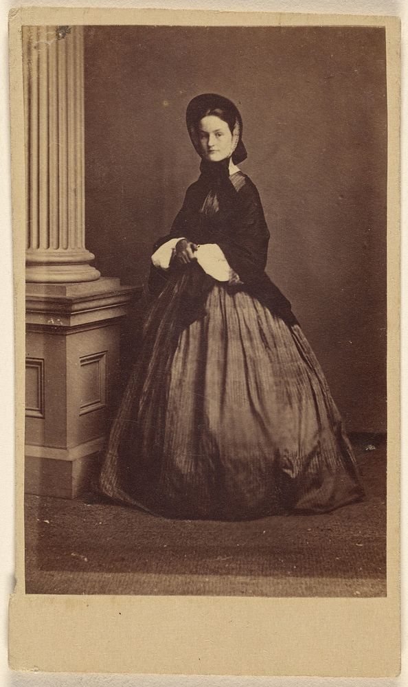 Unidentified woman wearing a bonnet, standing