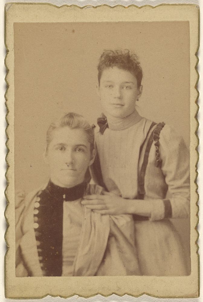 Mother seated, daughter standing