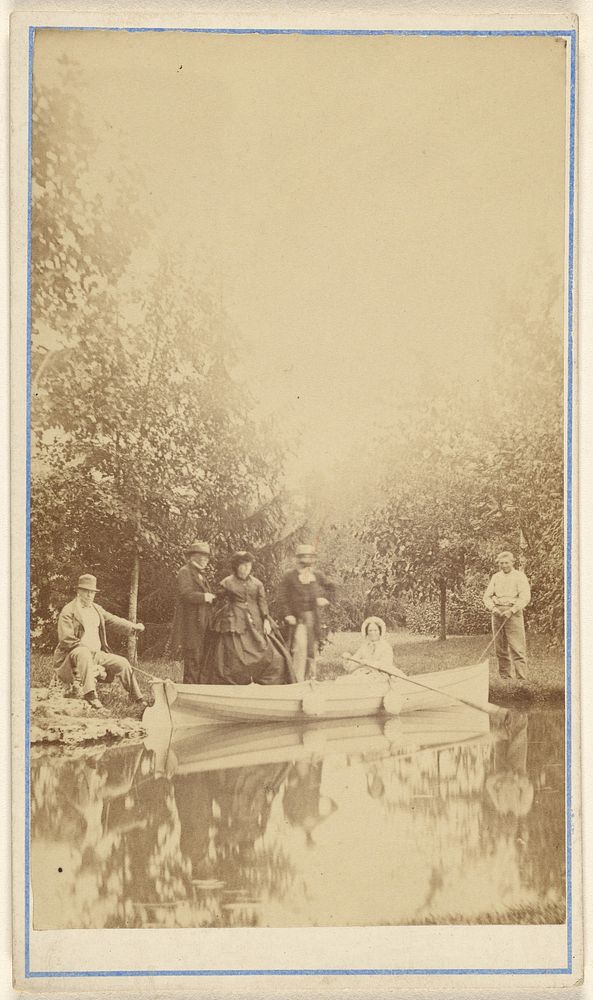 Group of people near a lake, one woman in a canoe