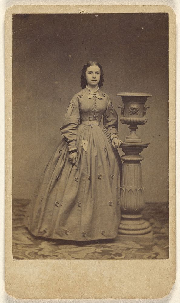 Unidentified woman, standing by Charles Miller