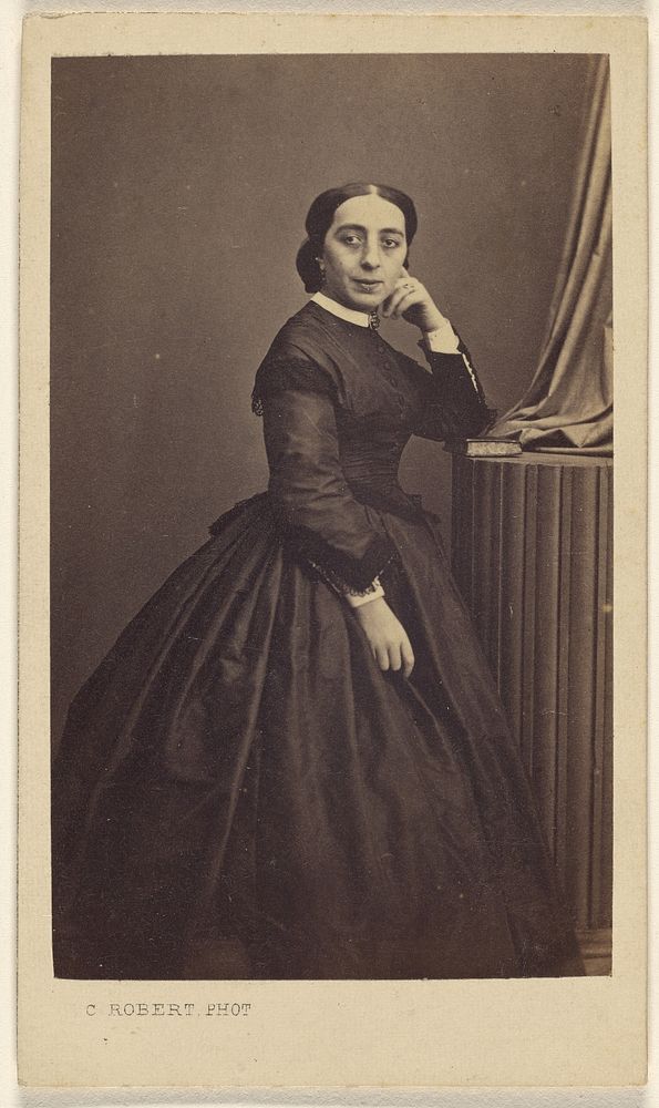 Unidentified woman standing, hand to cheek by C Robert