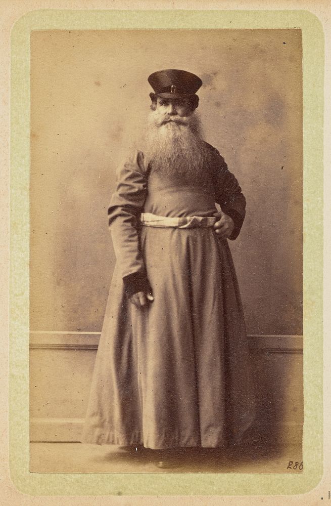 Bearded man dressed in a cassock and hat by William Carrick