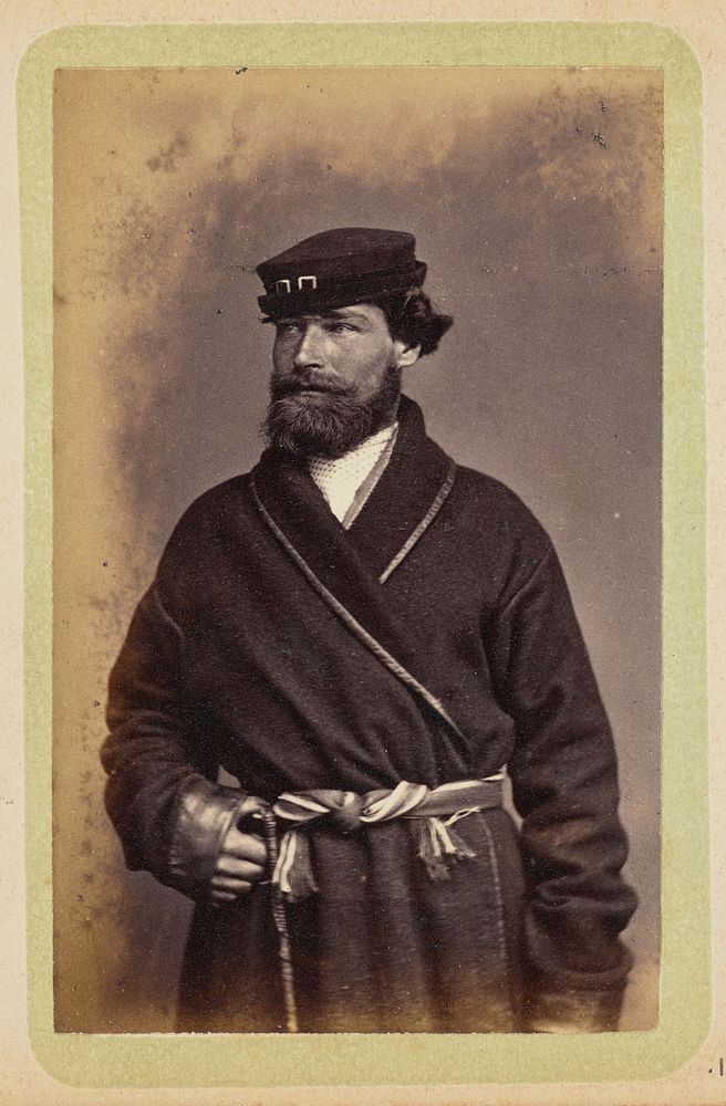 Man posing in dark coat and sash by William Carrick