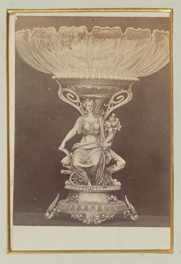 Ornate glass-top serving dish with a figurine of a woman at the base by Alexander Nichol