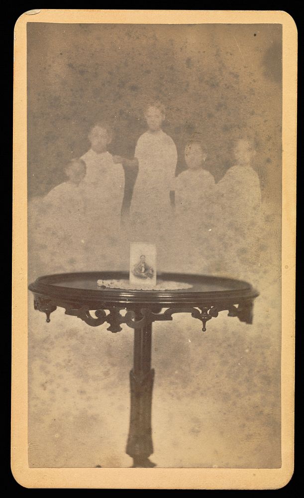 Five "spirits" in background with a photograph at center of table with a doily by William H Mumler and Helen F Stuart