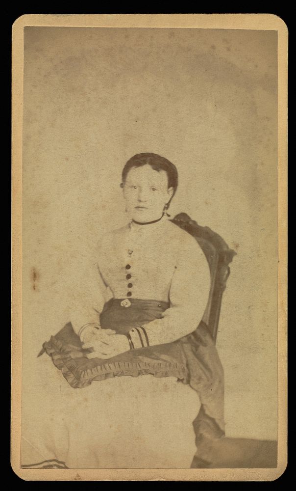 Unidentified woman wearing a white dress seated with a "spirit" by William H Mumler