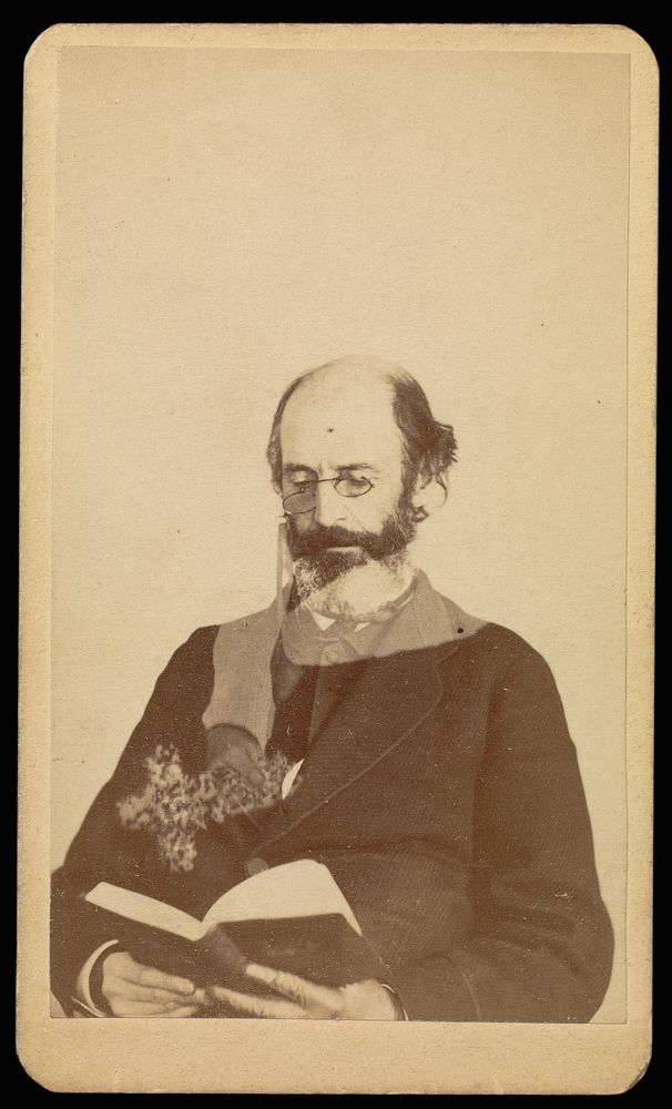 Unidentified balding, bearded man reading while seated by William H Mumler