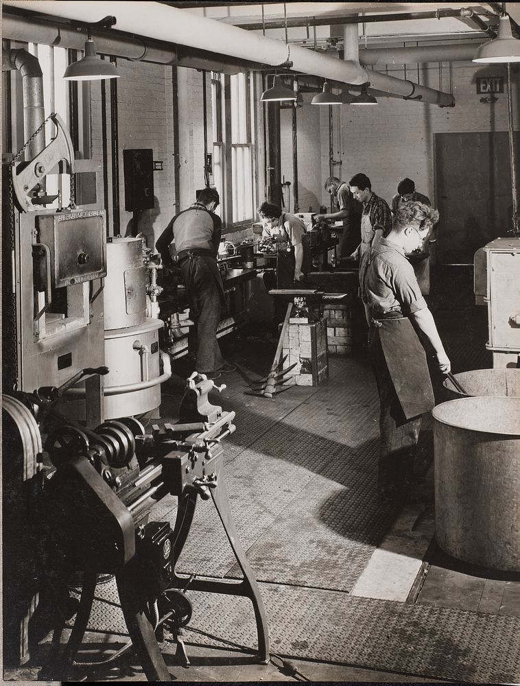 Six men work in a welding workshop by Arnold Eagle