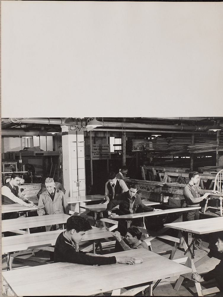 A group of men inspects wooden tables by Arnold Eagle